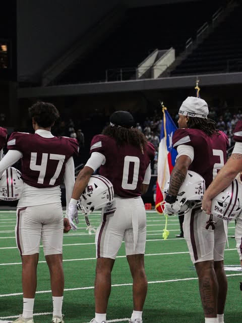 Football players standing together on the sideline