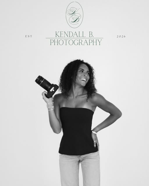 Black and white portrait of Kendall holding her camera
